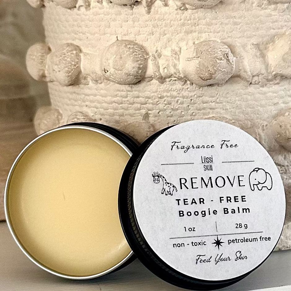 Open container of tear-free boogie balm with label on a textured surface